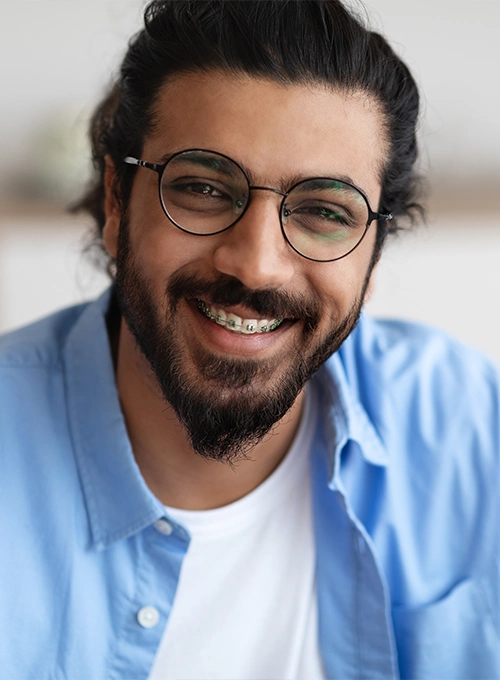 Man With Braces In Blue Dress Shirt Close-Up